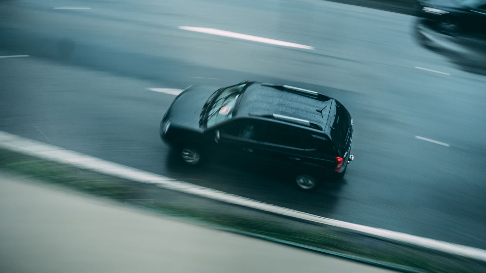 aerial view of black suv running on road